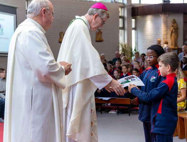 Emma and Eric present the school crest to Bishop Denis Nulty Emma and Eric present the school crest to Bishop Denis Nulty