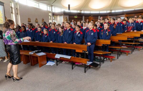 The choir directed by teacher Lisa Dooley sing the school anthem for the first time The choir directed by teacher Lisa Dooley sing the school anthem for the first time